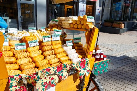ZAKOPANE, POLAND - MARCH 09, 2015: Sales of sheep cheeses named oscypek from the street stall at Krupowki, since February 02, 2007 oscypek is Polish regional product protected by EU lawのeditorial素材
