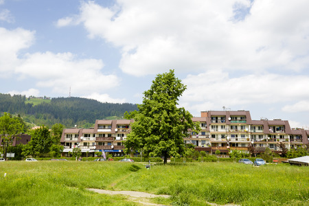 ZAKOPANE, POLAND - JUNE 11, 2015: Housing estate along the street Stolarczyk, residential buildings complex , architectural style for the city and the region were often built in the twentieth centuryのeditorial素材