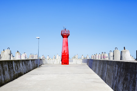 KOLOBRZEG, POLAND - JULY 17, 2015: Red signal navigation lantern, located on the breakwater eastern of the seaport, opened after the reconstruction of the entrance to the port of Kolobrzeg in 2012のeditorial素材