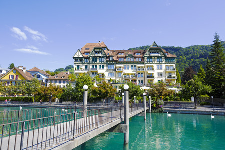 THUN, SWITZERLAND - SEPTEMBER 08, 2015: Goettibachsteg bridge with a length of approx. 40 meters, taken across the river Aare leads to beautiful building which houses the famous Italian restaurantのeditorial素材