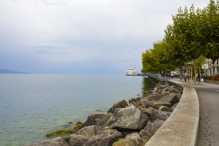 VEVEY, SWITZERLAND - SEPTEMBER 12, 2015: Modern vessel seen in the distance, named Lausanne, at jetty in Vevey. The vessel with a length of 78.8 meters was built in 1991のeditorial素材