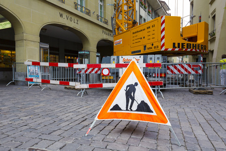 BERN, SWITZERLAND - SEPTEMBER 11, 2015: Due to repairs and the use of heavy vehicles, warning sign is placed on the road in the old town of Bern which is the 4th most populous city in the Countryのeditorial素材