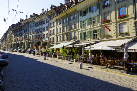BERN, SWITZERLAND - SEPTEMBER 13, 2015: Townhouses along the most visited street in the city with a...