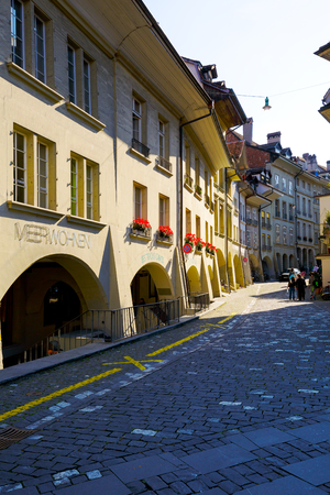 BERN, SWITZERLAND - SEPTEMBER 13, 2015: Arcades along the narrow street in downtown. The total length of the arcades in the city is estimated at 6 kmのeditorial素材