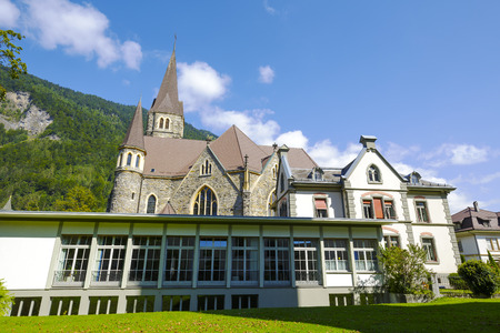 INTERLAKEN, SWITZERLAND - SEPTEMBER 07, 2015: Catholic Church towering over the other buildings in the city which attracts many tourists because of its charm and location in a important tourist spotのeditorial素材