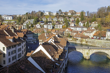 BERN, SWITZERLAND - DECEMBER 22, 2015: Aare River flows next to the historic city center. The...