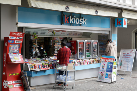 LUCERNE, SWITZERLAND - MAY 11, 2016: Unrecognized passers do some shopping at a kiosk. Retail sales in heavily used areas provides daily access to many needed products and small giftsのeditorial素材