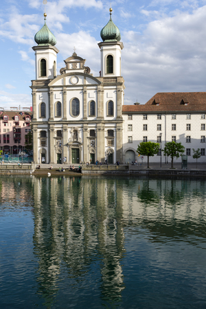 LUCERNE, SWITZERLAND - MAY 09, 2016: View towards the Jesuit Church located by the Reuss river in old town. It is widely believed to be the most beautiful Baroque church in Switzerlandのeditorial素材