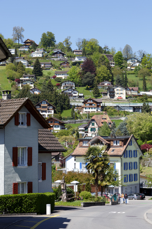 WEGGIS, SWITZERLAND - MAY 05, 2016: Residential houses in famous tourist destination that is frequently visited because of the many attractions in the town itself and its surroundingsのeditorial素材