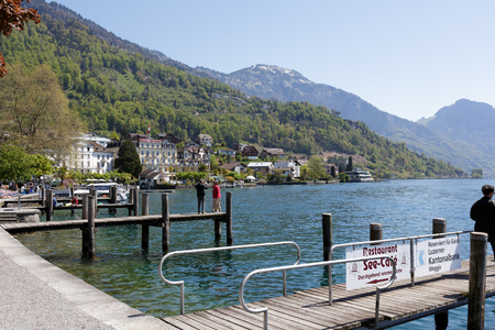 WEGGIS, SWITZERLAND - MAY 05, 2016: Wooden piers on the waterfront emphasize the tourist nature of the town on the shores of Lake Lucerne that provides many tourist attractionsのeditorial素材