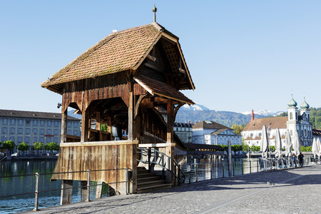 LUCERNE, SWITZERLAND - MAY 05, 2016: Entry to roofed wooden the Chapel Bridge that connects the two banks of the river Reuss and it is one of the Lucerne's most famous tourists attractionのeditorial素材