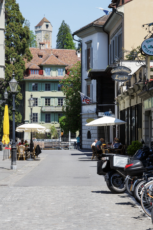 LUCERNE, SWITZERLAND - MAY 08, 2016: Residential building and the tower of stone that is part of old city walls named Musegg can be seen at the end of the streetのeditorial素材