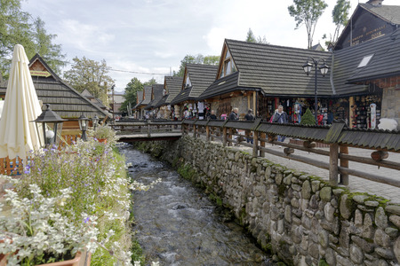 ZAKOPANE, POLAND - SEPTEMBER 23, 2016: Commercial pavilions that are called Goralskie Sukiennice was built in 2006 and are located by the stream and offers regional souvenirsのeditorial素材