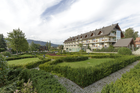 ZAKOPANE, POLAND - SEPTEMBER 23, 2016: Hotel Wersal that is located in a modern building with architecture reminiscent of the style of the region is surrounded by a beautiful garden providing peaceのeditorial素材