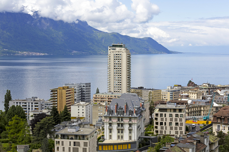 MONTREUX, SWITZERLAND - MAY 30, 2013: Cityscape and in the middle only one skyscraper it is seen from above complemented overlooking forested mountains on the other shore of Lake Genevaのeditorial素材