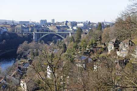 BERN, SWITZERLAND - DECEMBER 26, 2015: Vegetation enriches the landscape of the city. High bridge spanning the river Aare and the dense urbanization can be seenのeditorial素材