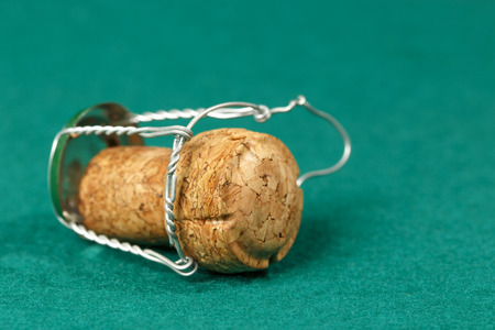 Cork of a sparkling wine  is shown on a green backgroundの写真素材