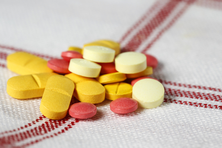Several different pills have been arranged on the fabricの写真素材