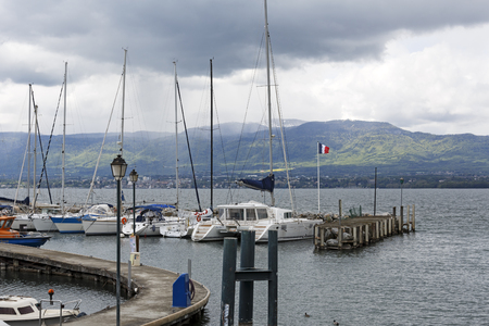 Yvoire, France - May 24, 2013: Sailboats anchored along the pier at the port on Lake Geneva.のeditorial素材