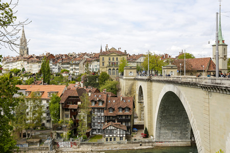 Bern, Switzerland - April 17, 2017: Massive Nydeggbruecke bridge over the River Aare leads to the...