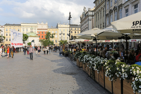 Krakow, Poland - May 25, 2017: Outdoors restaurant that is located on the old town square surrounded by historic architecture. There are many people who enjoys their time in the cityのeditorial素材