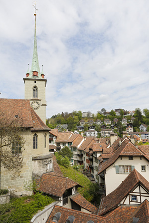 Bern, Switzerland - April 17, 2017: The roofs of a housing estate and a church belfry with its tall spire in the historic part of the cityのeditorial素材