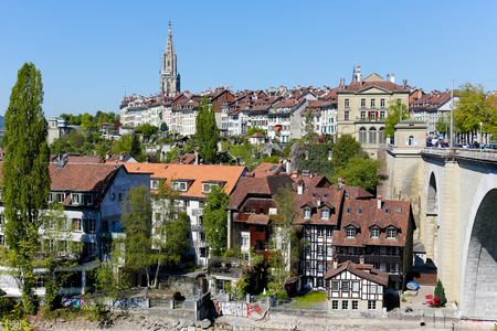 Bern, Switzerland - April 21, 2017: The variety of architecture of old town. Townhouses on two levels in the city, cathedral and stone bridge over the river Aare can be seenのeditorial素材