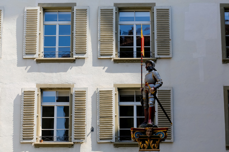Bern, Switzerland - April 20, 2017: The Banneret fountain is seen against the backgrond of facade of the building, whose windows are equipped with wooden shuttersのeditorial素材