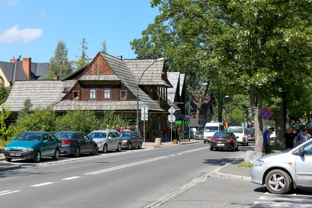 Zakopane, Poland - August 08, 2017: Traffic in the city. Villa made of wood, which was probably built in 1901 is seen in a distance. This house formerly was known as The Giewontowkaのeditorial素材