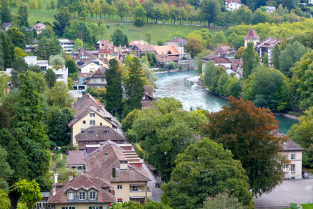 Bern, Switzerland - September 18, 2017: The houses situated down by the river in this city are surrounded by greenery which, combined with the proximity of the flowing water makes it like in the parkのeditorial素材