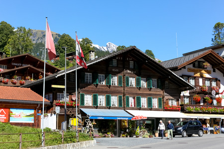 Grindelwald, Switzerland - 21 September 2017: Wooden building with green shutters is an example of...