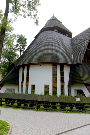 Zakopane, Poland - August 15, 2017: Church with a steep and slopping roof. It is the Church of Divine Mercy that built in 1994 and is seen on a cloudy day.のeditorial素材