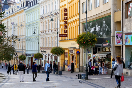 Karlovy Vary, Czechia - September 11, 2017: The street view shows the beauty of a row of colorful tenement houses. There are people walking there and some of them look at nearby shop windowsのeditorial素材