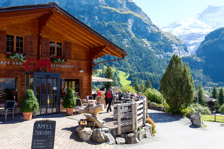 Grindelwald, Switzerland - 21 September 2017: A wooden house that houses a restaurant and a cafe offers its guests unforgettable views of beautiful alpine scenery.のeditorial素材
