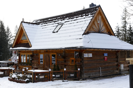 Zakopane, Poland - March 21, 2018: The wooden building, which was built in the style of a mountain cottage, houses a restaurant and a cafe. This is shown here during winter.のeditorial素材
