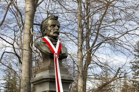 Zakopane, Poland - November 10, 2018: A bust of Tytus Chalubinski. On the occasion of the 100th anniversary of Poland's regaining independence white and red colors adorns this monument.のeditorial素材