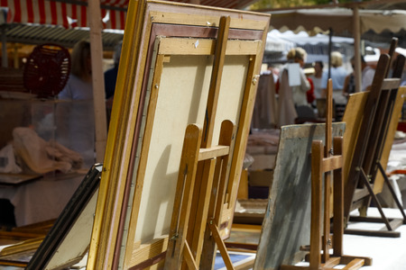 Nice, France - September 17, 2018: Paintings in frames on easels are shown from behind at the flea market in Cours Saleya, the famous City Market offering antiques and a variety of other products.のeditorial素材