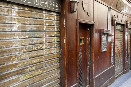 Nice, France - September 21, 2018: Frontage of the Bar which is located on the ground floor of the building in a narrow street. Closed rolling blinds show that this bar is now closed.のeditorial素材