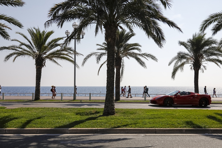 Nice, France - September 21, 2018: Promenade des Anglais leads along the sea shore. It is a wonderful promenade with palm trees, a bicycle path and a street on which sometimes luxury cars drive.のeditorial素材