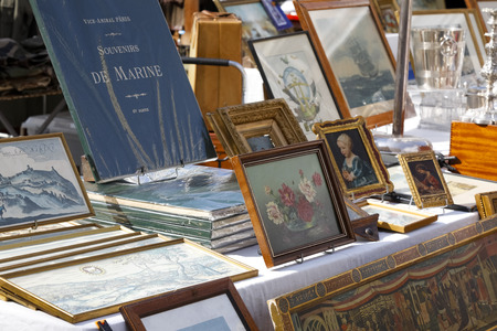 Nice, France - September 24, 2018: Paintings, books and other retro items are on sale at one of the stands at the famous Cours Saleya market.のeditorial素材