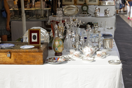 Nice, France - September 17, 2018: Retro items arranged on the stall during the famous market called Cours Saleya. There are glassware, metal, wooden products for various purposes.のeditorial素材