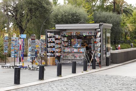Nice, France - September 18, 2018: Kiosk with magazines, newspapers and selection of postcards and other different souvenirs, which are exhibited here on external racks.のeditorial素材