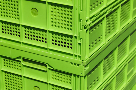 Two green plastic crates are placed one on top of the other.の写真素材