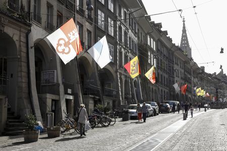 Bern, Switzerland - April 22, 2019: The facades of many historic buildings on this street are in the...