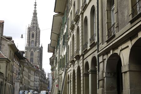Bern, Switzerland - April 16, 2018: The old town houses are on both sides of the street and there is...