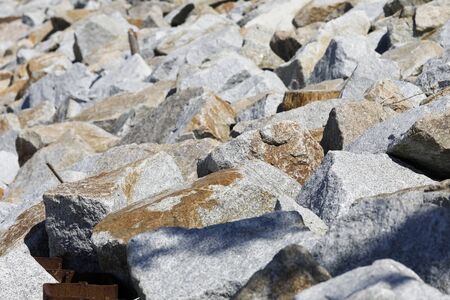 There are stones protecting dunes from the ominous influence of dangerous sea waves during stormy...