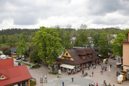 Zakopane, Poland - June 01, 2019: Here Krupowki Street intersects with another street. You can see here a few buildings, a lot of trees and of course tourists walking around.のeditorial素材