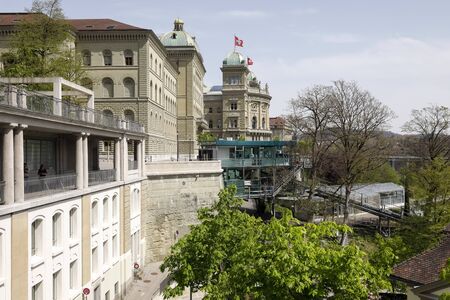 Bern, Switzerland - April 22, 2019: A large building of the Federal Palace and a small upper station of the cable car. With this cable car you can go down to Marzili.のeditorial素材