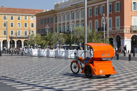 Nice, France - September 21, 2018: Three-wheeled vehicle, usually driven by young drivers, is an idea for a comfortable sightseeing tour of the city. Here it is waiting for tourists on Massena Square.のeditorial素材