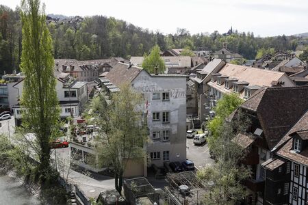 Bern, Switzerland - April 23, 2019: There is a townhouse on which the remains of old advertising...